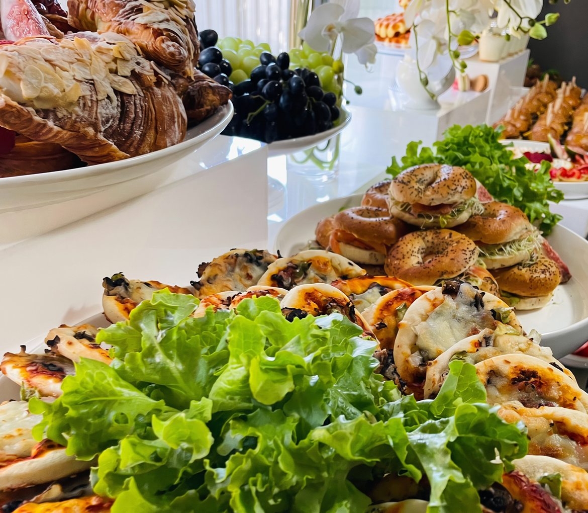 Bagels, croissants and mini pizzas on a styled table