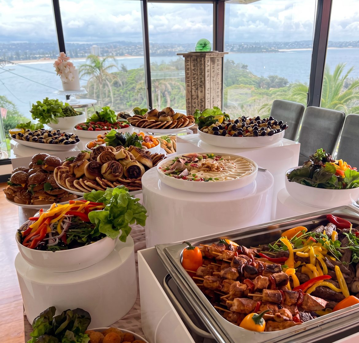 A buffet on white risers with a harbour view
